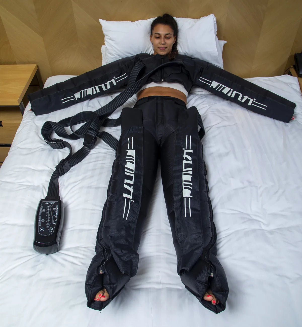 athlete using pneumatic compression boots for faster muscle recovery after training
