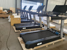 Multiple commercial smart treadmills installed inside professional gym environment.