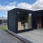 Infrared heating panels integrated into interior walls of modular sauna cabin system.