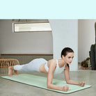 Woman holding plank on yoga mat with alignment lines for proper posture