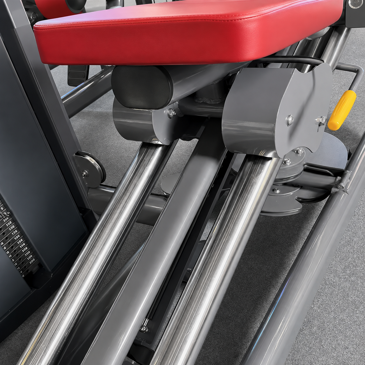 Commercial seated leg press polished steel guide rails and carriage detail