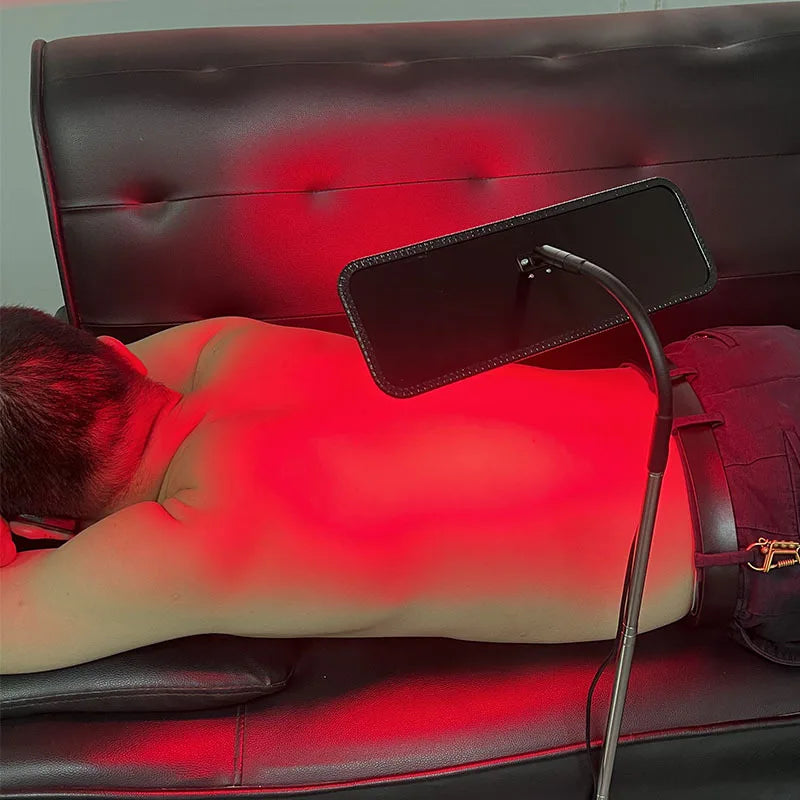 Using red light therapy panel during meditation and home wellness routine
